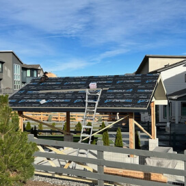 roofer working on an outdoor pavilion with an underlayment