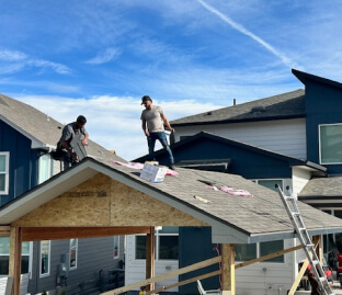 Roofing workers installing a pavilion roof in residential area