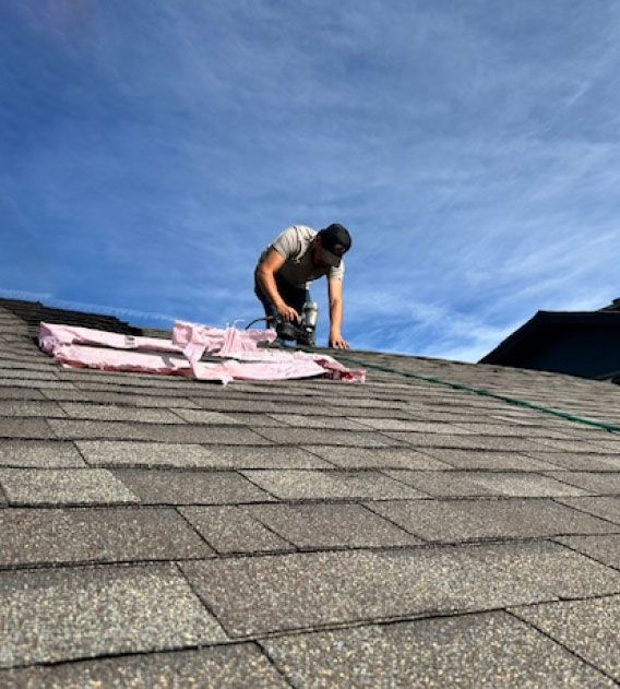 Professional roofer working on roof replacement on a Colorado home.