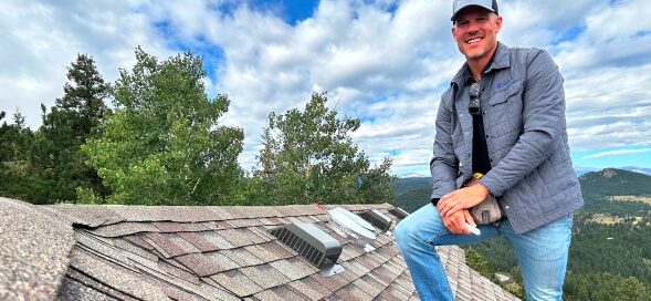 Roofing contractor standing on a residential roof