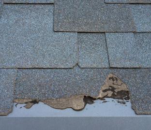 Roof shingles with damages like cracks and granule loss