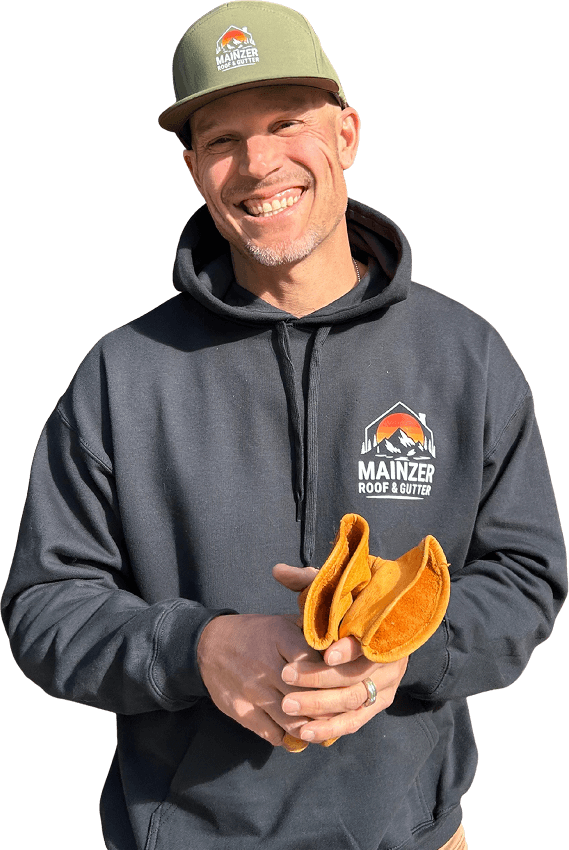 male roofing contractor wearing sweater and cap with Mainzer Company logo