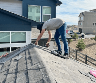 Roofer performing an inspection for asphalt shingle repair and maintenance