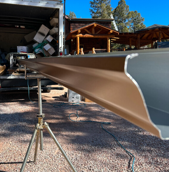 gutter being produced by a seamless gutter machine