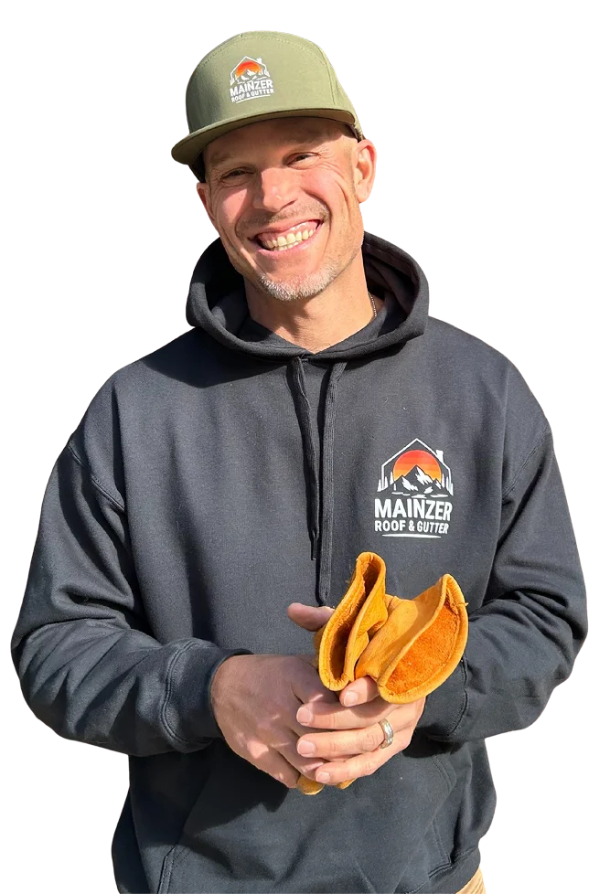 male roofing contractor wearing sweater and cap with Mainzer Company logo